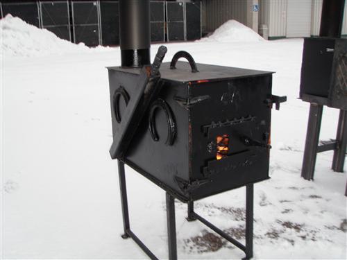 Black woodstove burning wood.