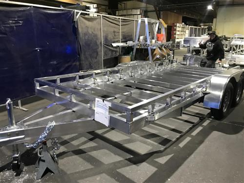 An Aluminum trailer made to haul cars is shown in a Weld Shop