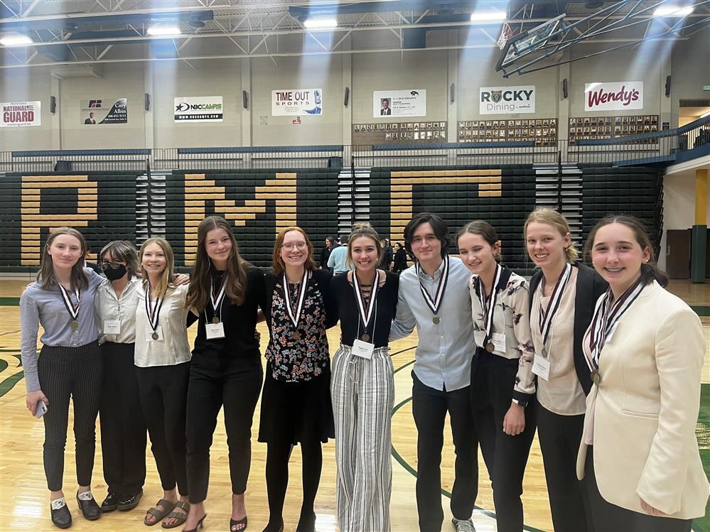 2020 HOSA State Competition with 10 students standing arm in arm in a gymnasium. 2020 HOSA State Competition with 10 students standing arm in arm in a gymnasium.