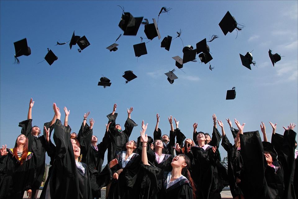 Image of students tossing graduation caps in the air Image of students tossing graduation caps in the air
