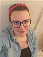 Mrs. Rogers wearing glasses, a pink headband and a denim jacket. Mrs. Rogers wearing glasses, a pink headband and a denim jacket.