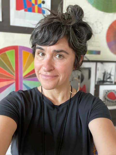 Ms H posing in front of some pretty art